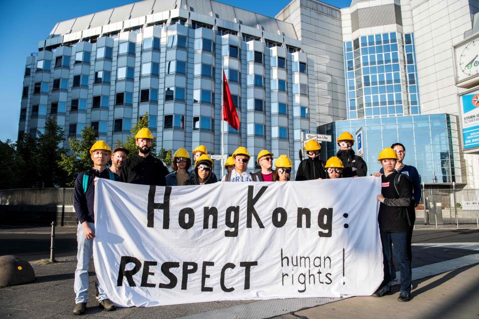 Pro Hong Kong supporters wear a patch on one eye and hold a banner calling for respect during a demonstration on August 23, 2019 outside the Chinese embassy in Berlin. - Ten weeks of demonstrations have plunged Hong Kong, the international finance hub, into crisis, with communist-ruled mainland China taking an increasingly hardline tone. Protesters, like in Hong Kong, wear symbolically eye patches, after a woman suffered an eye injury which demonstrators blamed on a bean-bag round fired by police. (Photo by Paul Zinken / dpa / AFP) / Germany OUT        (Photo credit should read PAUL ZINKEN/AFP/Getty Images)