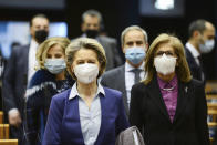 European Commission President Ursula von der Leyen, center left, and European Health Commissioner Stella Kyriakides, second right, arrives for a debate on the united EU approach to COVID-19 vaccinations at the European Parliament in Brussels, Wednesday, Feb. 10, 2021. (Johanna Geron, Pool via AP)