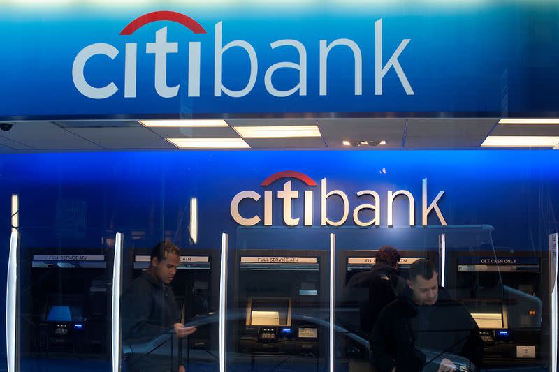 FILE PHOTO: Customers wait at an ATM at a Citibank branch in New York