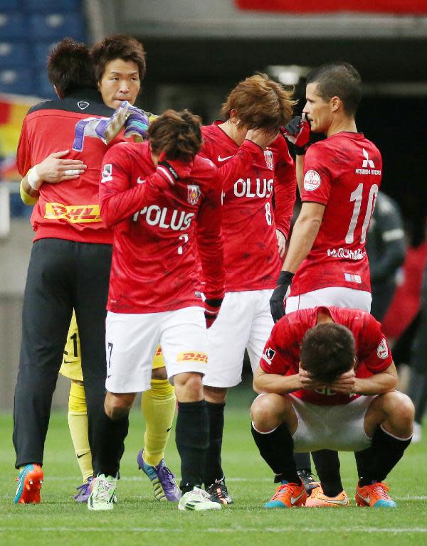 Urawa Reds' players react after losing a match against Nagoya Grampus, in Saitama, on December 6, 2014