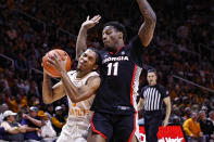 Tennessee guard Zakai Zeigler (5) collides with Georgia guard Justin Hill (11) on a drive to the basket during the first half of an NCAA college basketball game Wednesday, Jan. 25, 2023, in Knoxville, Tenn. (AP Photo/Wade Payne)