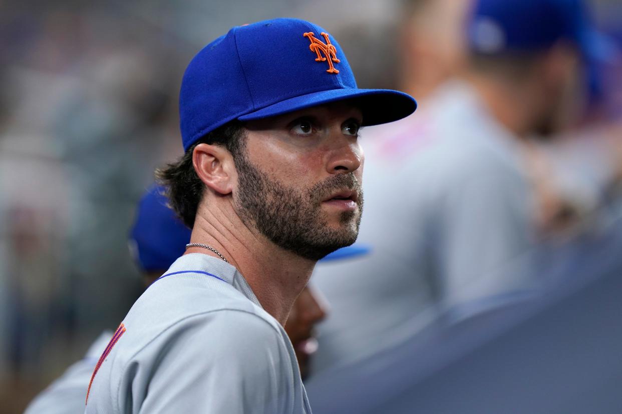 New York Mets' Tyler Naquin looks out from the dugout during the fifth inning of a baseball game against the Miami Marlins, Friday, July 29, 2022, in Miami. New York acquired the left-handed-hitting outfielder and lefty reliever Phillip Diehl from on Thursday night in a deal for two teenage minor leaguers, outfielder Hector Rodriguez and right-hander Jose Acuna.