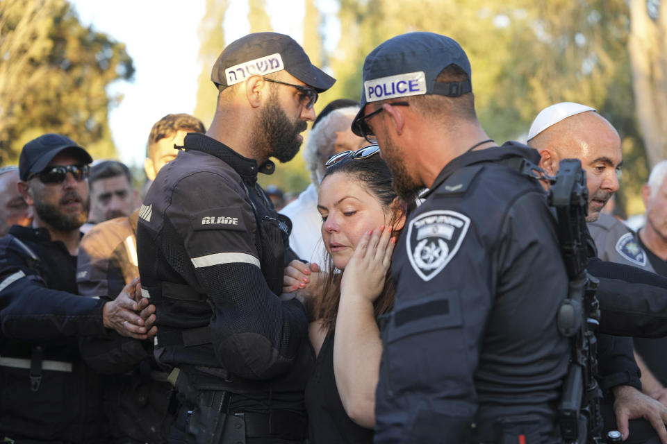 Mourners attend the funeral of Chen Amir in Kibbutz Re'im, Israel, Sunday, Aug 6, 2023. On Saturday a Palestinian gunman shot and killed Amir, 42, an Israeli security guard in central Tel Aviv. The attacker was shot and killed. (AP Photo/Tsafrir Abayov)