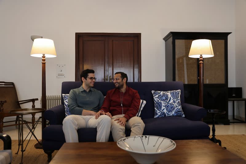 Parth Phiroze Mehrotra, 36, and his partner Uday Raj Anand, 35, smile as they pose for a picture at their home in New Delhi