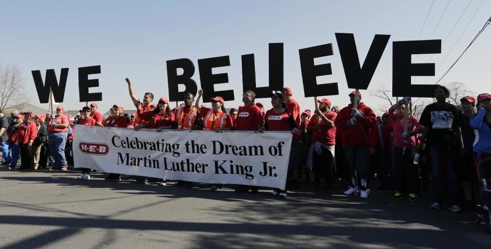 Letters spelling "We Believe" are carried by a group during a march honoring Martin Luther King Jr., Monday, Jan. 20, 2014, in San Antonio. (AP Photo/Eric Gay)