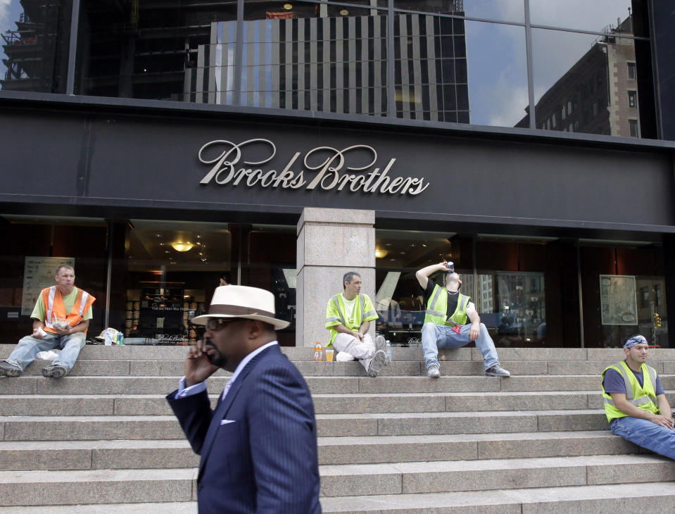 CORRECTS DATE OF PHOTO TO AUG. 4, 2011, INTEAD OF SEPT. 11, 2001 - FILE - In this Aug. 4, 2011, file photo, a man passes a Brooks Brothers store on Church Street in New York's financial district. The 200-year-old fashion retailer that says it's put 40 U.S. presidents in its suits, is filing for bankruptcy protection on Wednesday, July 8, 2020. (AP Photo/Mark Lennihan, File)