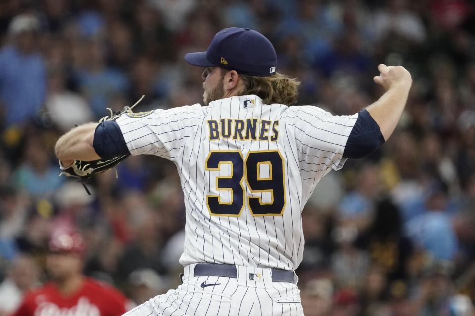 Milwaukee Brewers starting pitcher Corbin Burnes throws during the first inning of a baseball game against the Cincinnati Reds Sunday, Aug. 7, 2022, in Milwaukee. (AP Photo/Morry Gash)