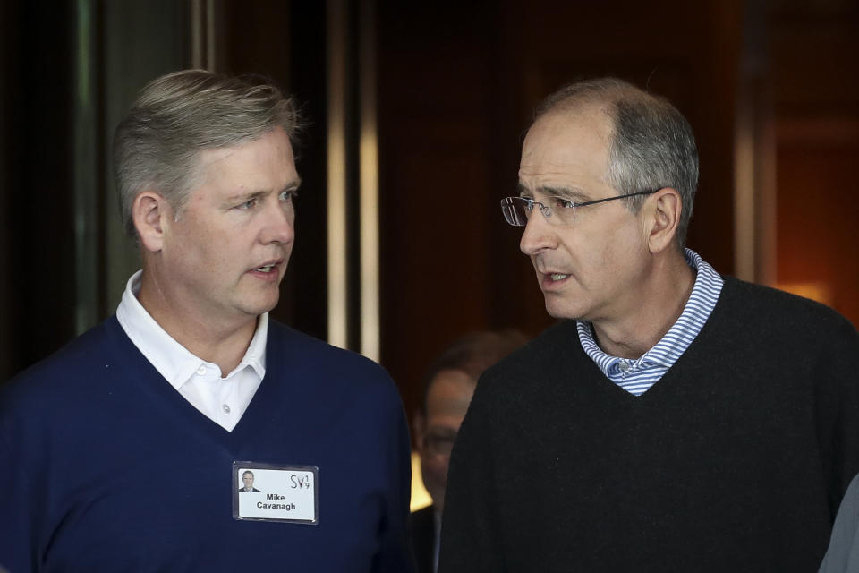 (L-R) Michael Cavanagh, Comcast president and interim CEO at NBCUniversal, talks with Brian Roberts, chief executive officer of Comcast