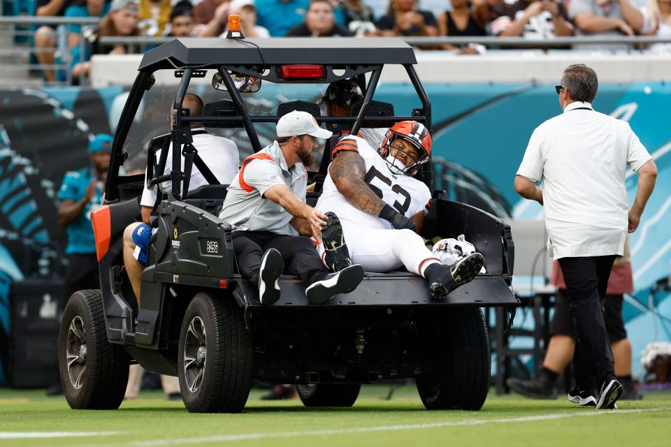 Cleveland Browns center Nick Harris (53) is carted off the field during the first quarter of a preseason game against the Jacksonville Jaguars.