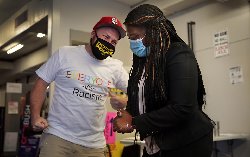 Cori Bush celebrates with campaign worker and fellow activist Mike Lhotak as she arrives at her campaign headquarters in Northwoods, Mo., on Wednesday, Aug. 5, 2020. Bush pulled a stunning political upset, beating 20-year incumbent Rep. William Lacy Clay in Missouri’s 1st District Democratic primary. The district that covers St. Louis and north St. Louis County is overwhelmingly Democratic and Bush is heavily favored in November. (Robert Cohen/St. Louis Post-Dispatch via AP)