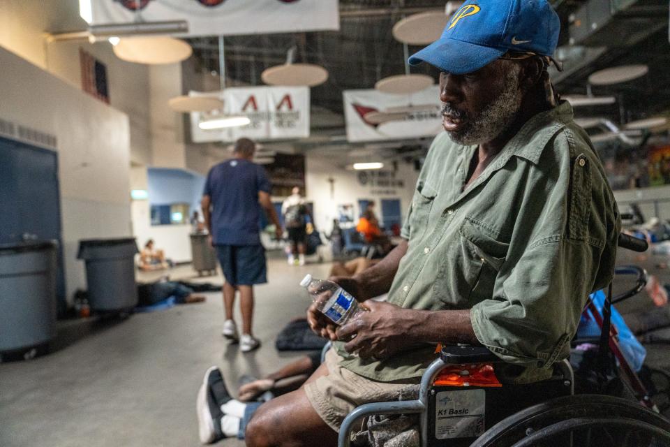 Kelvin Hall cools off from the heat as he sits inside St. Vincent de Paul's dining room at the Human Services Campus in Phoenix on July 20, 2023.