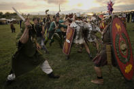 Participants in the Romula Fest historic reenactment event clash during a battle in the village of Resca, Romania, Saturday, Sept. 3, 2022. (AP Photo/Vadim Ghirda)