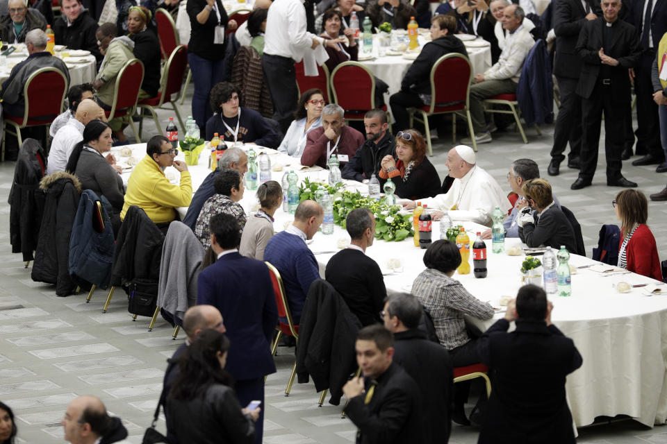 Pope Francis sits at a table during a lunch, at the Vatican, Sunday, Nov. 18, 2018. Pope Francis is offering several hundred poor people, homeless, migrants, unemployed a lunch on Sunday as he celebrates the World Day of the Poor with a concrete gesture of charity in the spirit of his namesake, St. Francis of Assisi.(AP Photo/Andrew Medichini)