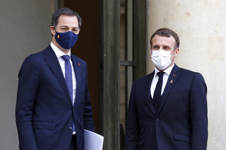 French President Emmanuel Macron, right, welcomes Belgium's Prime Minister Alexander De Croo, prior to a meeting, at the Elysee Palace, in Paris, France, Tuesday, Dec. 1, 2020. (AP Photo/Thibault Camus)