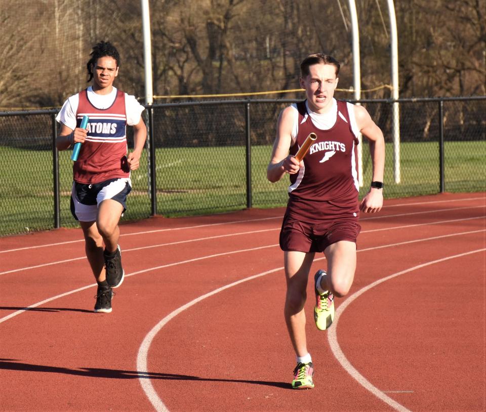 Nick Aulisi (right) runs the first leg of the four-by-400 relay for Frankfort-Schuyler during Monday's dual meet against the Utica Academy of Science.