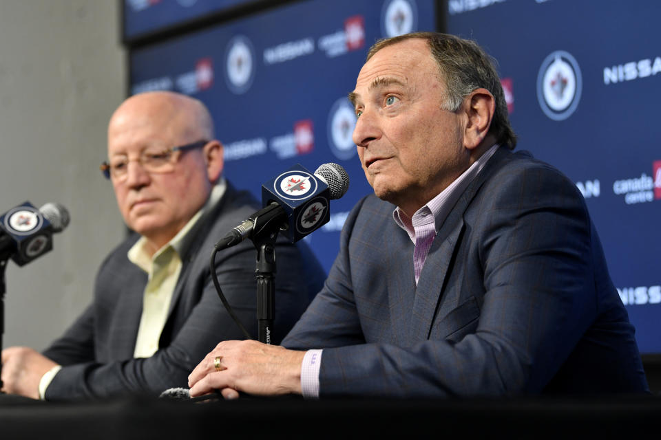 NHL Commissioner Gary Bettman, right, and Deputy Commissioner Bill Daly speak to reporters before an NHL hockey game between the St. Louis Blues and the Winnipeg Jets on Tuesday, Feb. 27, 2024, in Winnipeg, Manitoba. (Fred Greenslade/The Canadian Press via AP)