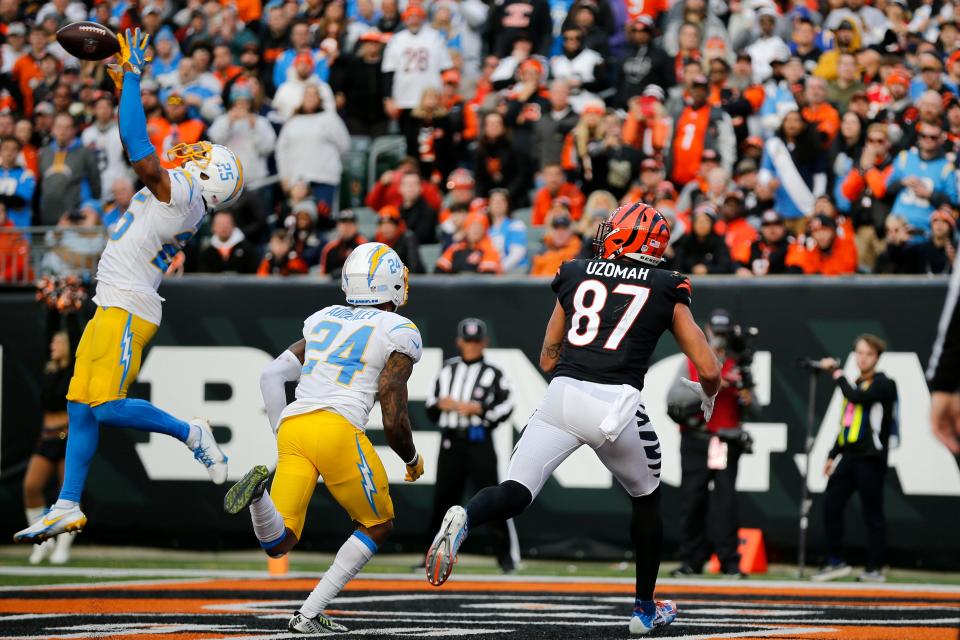 Los Angeles Chargers cornerback Chris Harris (25) intercepts a pass intended for Cincinnati Bengals tight end C.J. Uzomah (87) in the end zone in the fourth quarter of the NFL Week 13 game between the Cincinnati Bengals and the Los Angeles Chargers at Paul Brown Stadium in Cincinnati on Sunday, Dec. 5, 2021. The Chargers coasted to a 41-22 win over the Bengals. 