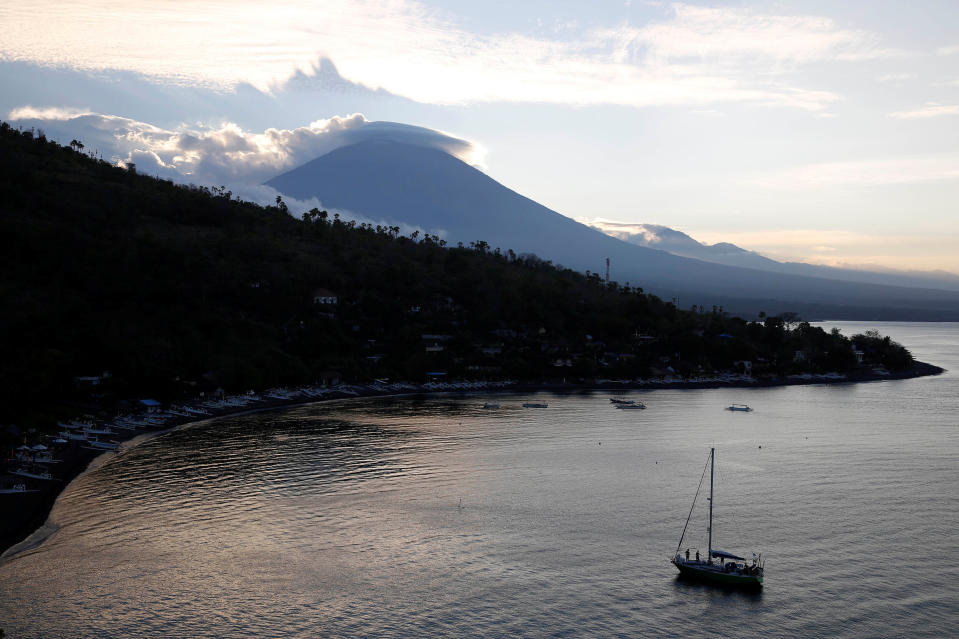 <p>A sailboat is seen at the sun sets behind Mount Agung, a volcano on the highest alert level, in Amed on the resort island of Bali, Indonesia on Sept. 25, 2017. (Photo: Darren Whiteside/Reuters) </p>