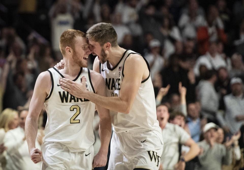 Wake Forest guard Cameron Hildreth (2) and forward Andrew Carr (11) celebrate in overtime of an NCAA college basketball game against Miami, Saturday, Jan. 6, 2024, in Winston-Salem, N.C. | Allison Lee Isley, The Winston-Salem Journal via Associated Press