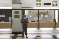 Former Malaysia Prime Minister Najib Razak, looks at his phone, before leaving the Kuala Lumpur High Court complex in Kuala Lumpur, Malaysia, Tuesday, July 28, 2020. The court has sentenced Razak to serve 12 years in prison after finding him guilty in the first of several corruption trials linked to the multibillion-dollar looting of a state investment fund that brought down his government two years ago. (Fazry Ismail/Pool Photo via AP)