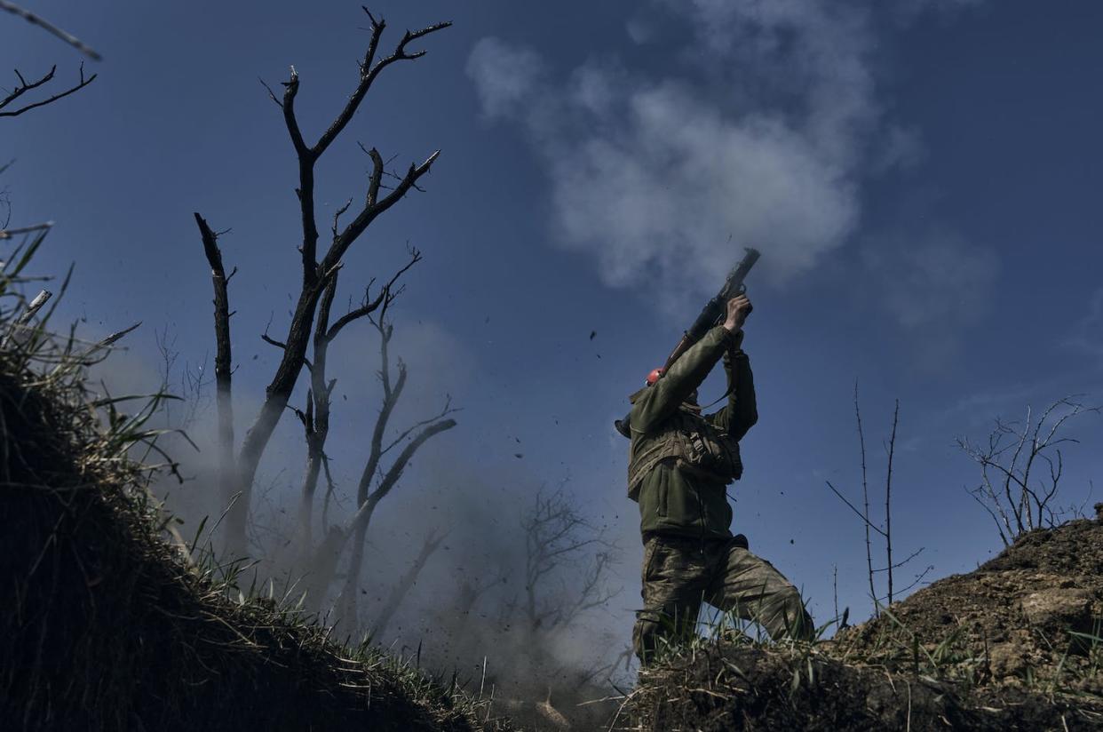 A Ukrainian soldier fires a grenade launcher on the frontline in Bakhmut in the Donetsk region of Ukraine. (AP Photo/Libkos)
