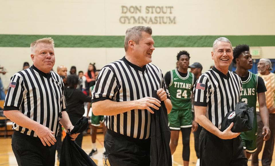 Lance Ringler, left, Tony Richert and Casey Gaynor walk off the court Tuesday, Jan. 2, 2024, during the game at Municipal Gardens in Indianapolis. Gaynor, a high school basketball official, completed his journey to officiate a game at every high school in the state.