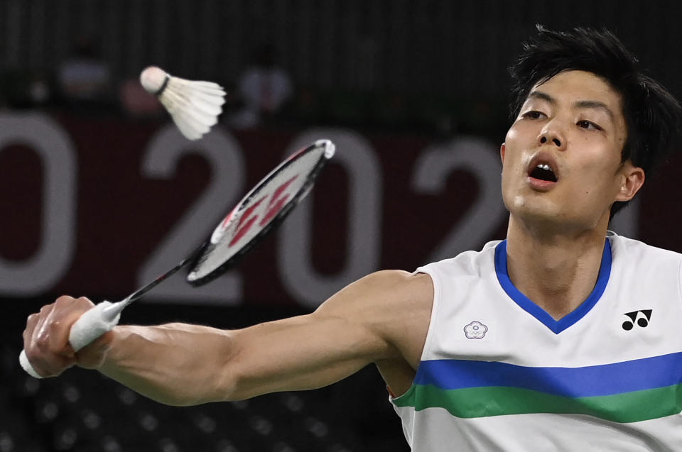 Taiwan's Chou Tien-chen hits a shot to China's Chen Long in their men's singles badminton quarter final match during the Tokyo 2020 Olympic Games at the Musashino Forest Sports Plaza in Tokyo on July 31, 2021. / AFP / Alexander NEMENOV