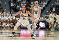 UConn's Nika Muhl (10) and UConn's Dorka Juhasz (14) react after teammate UConn's Lou Lopez-Senechal hit a 3 point basket at the end of the quarter in the first half of an NCAA college basketball game against South Carolina, Sunday, Feb. 5, 2023, in Hartford, Conn. (AP Photo/Jessica Hill)