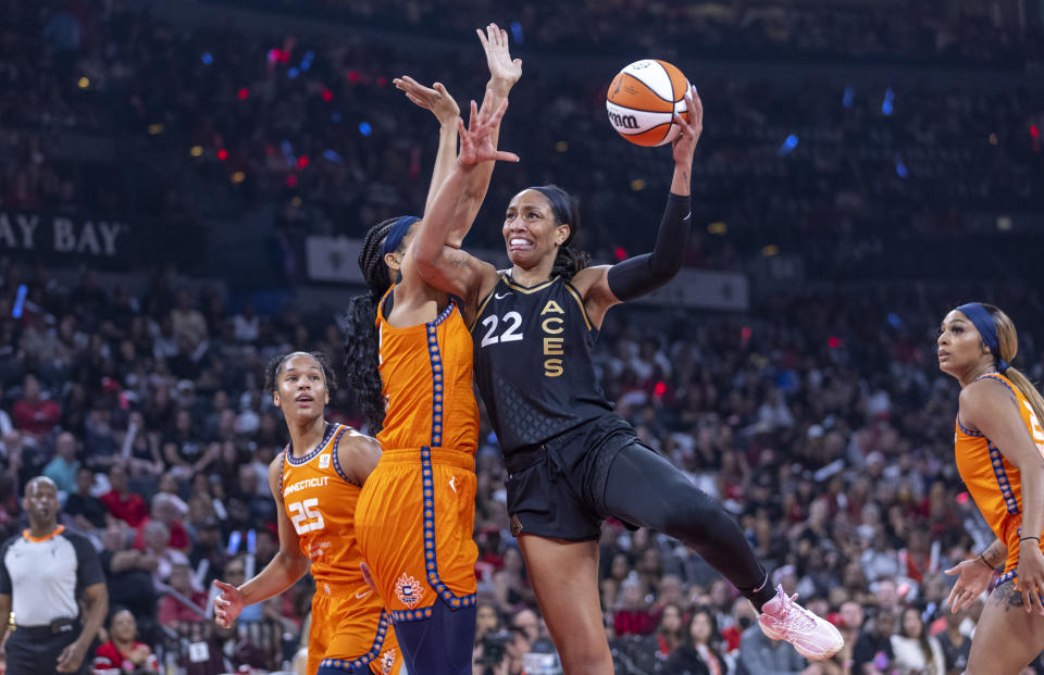 Las Vegas Aces forward A'ja Wilson (22) posts up for a shot over Connecticut Sun center Brionna Jones during the first half in Game 1 of a WNBA basketball final playoff series Sunday, Sept. 11, 2022, in Las Vegas. (AP Photo/L.E. Baskow)