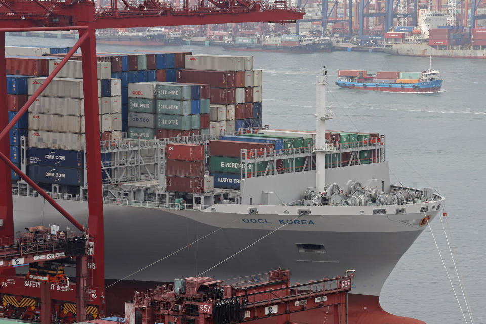 Gantry cranes load cargos onto the container ship at the port of Kwai Tsing Container Terminals in Hong Kong, Friday, May 24, 2019. Kwai Tsing Container Terminals is one of the busiest ports in the world. (AP Photo/Kin Cheung)