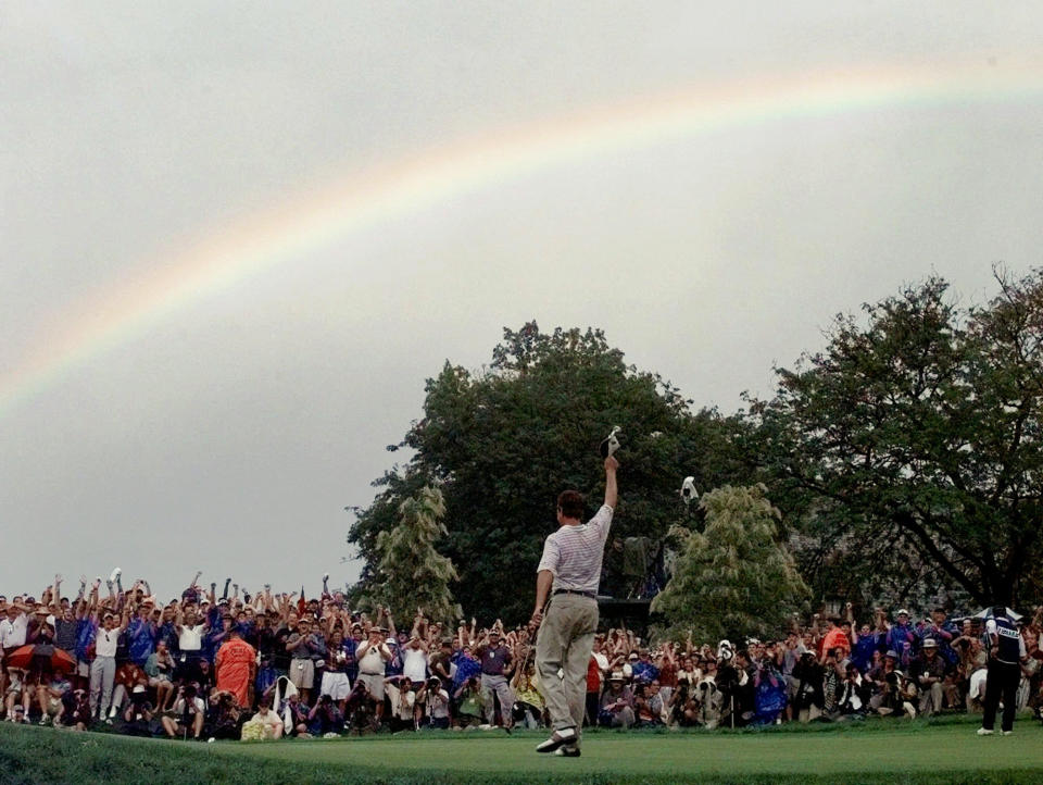 FILE - This photo by Associated Press photographer Elise Amendola shows a rainbow above golfer Davis Love III after he won the PGA Championship at Winged Foot Golf Club in Mamaroneck, N.Y., Sunday, August 17, 1997. Amendola, who recently retired from the AP, died Thursday, May 11, 2023, at her home in North Andover, Mass., after a 13-year battle with ovarian cancer. She was 70. (AP Photo/Elise Amendola, File)