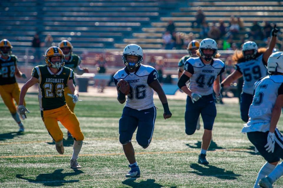 Rosemont Wolverines running back Wayshawn Parker (36) splits the Argonaut Mustangs defense en route to a touchdown to tie the game during the second quarter of the CIF Sac-Joaquin Section Division VI championship game on Saturday, Nov. 27, 2021, at Hughes Stadium in Sacramento. The Mustangs won 31-20.