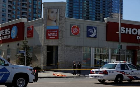 Officers at the scene - Credit: Chris Donovan/Reuters