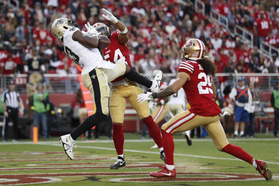 New Orleans Saints tight end Juwan Johnson, left, cannot catch a pass while being defended by San Francisco 49ers linebacker Fred Warner (54) and safety Talanoa Hufanga (29) during the second half of an NFL football game in Santa Clara, Calif., Sunday, Nov. 27, 2022. (AP Photo/Jed Jacobsohn)