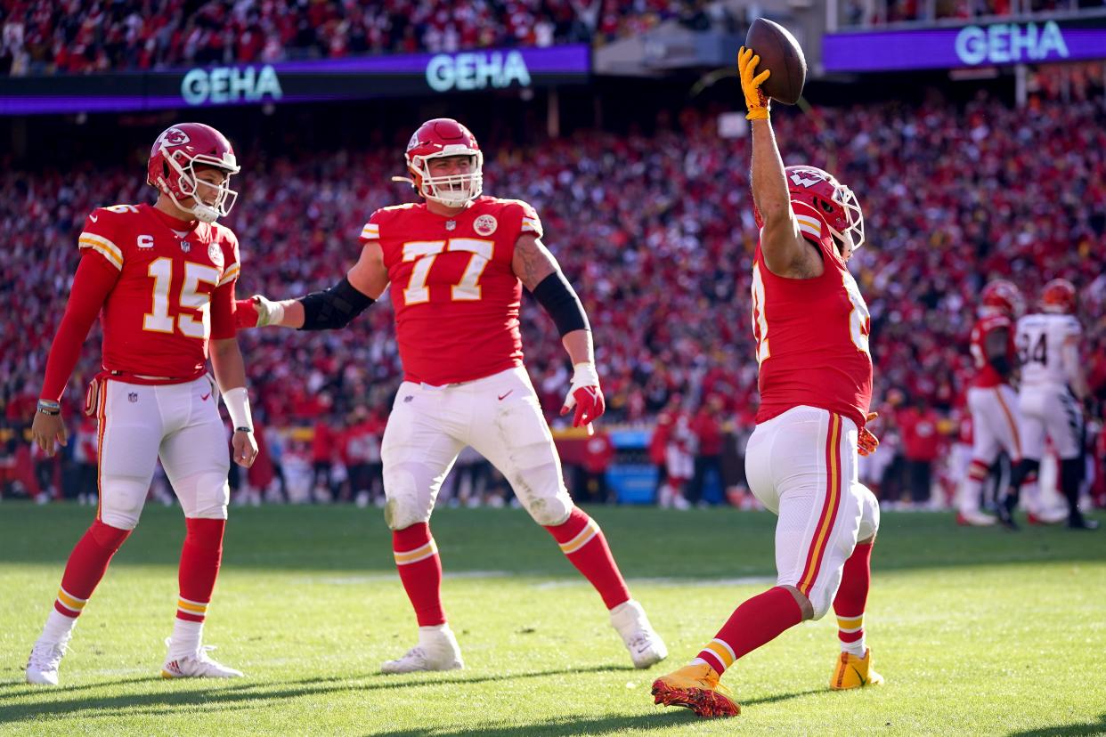 Kansas City Chiefs tight end Travis Kelce (87) celebrates a touchdown catch with Kansas City Chiefs quarterback Patrick Mahomes (15) and Kansas City Chiefs offensive tackle Andrew Wylie (77) in the second quarter during the AFC championship NFL football game, Sunday, Jan. 30, 2022, at GEHA Field at Arrowhead Stadium in Kansas City, Mo. 