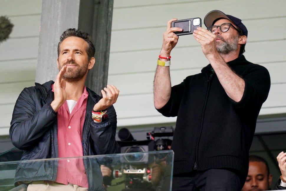 Wrexham Co-Owner, Ryan Reynolds (left) and Hugh Jackman in the stands before the Sky Bet League Two match at the SToK Racecourse, Wrexham