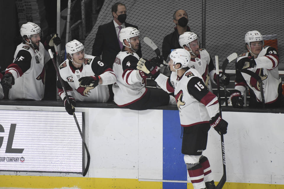 Arizona Coyotes center John Hayden (15) is congratulated after scoring against the Los Angeles Kings during the first period of an NHL hockey game, Saturday, April 24, 2021, in Los Angeles. (AP Photo/Michael Owen Baker)