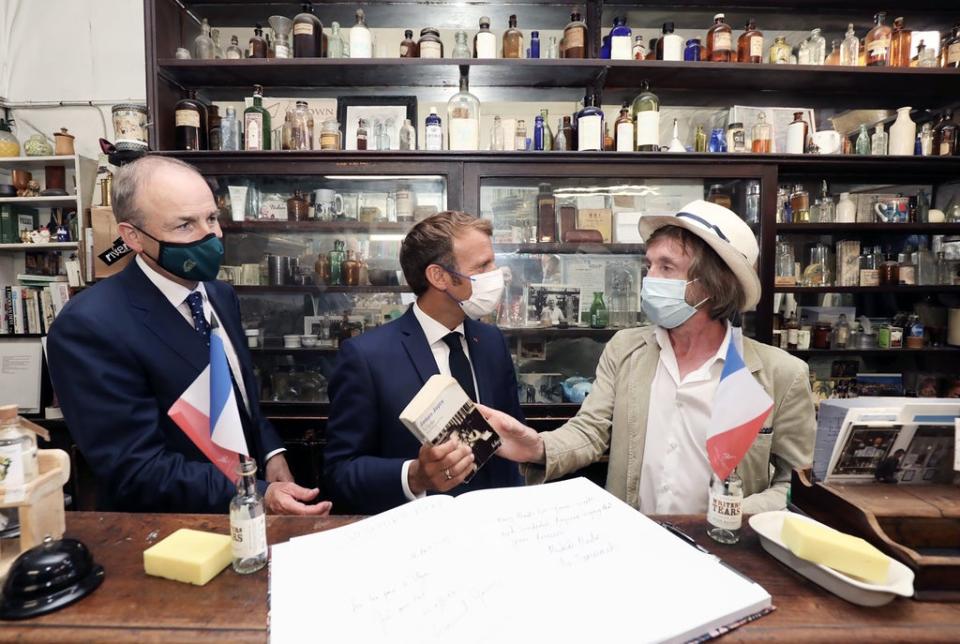 French President Emmanuel Macron with Taoiseach Micheal Martin at Sweny’s pharmacy, the Dublin chemist shop in James Joyce’s novel Ulysses. (Julien Behal/PA) (PA Media)