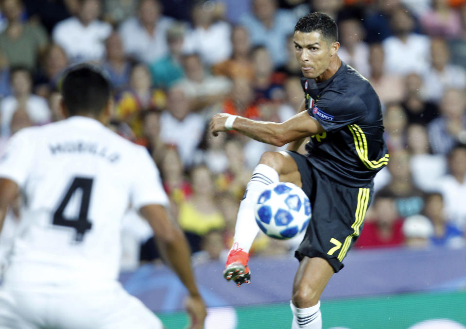 Juventus forward Cristiano Ronaldo goes for the ball during the Champions League, group H soccer match between Valencia and Juventus, at the Mestalla stadium in Valencia, Spain, Wednesday, Sept. 19, 2018. (AP Photo/Alberto Saiz)