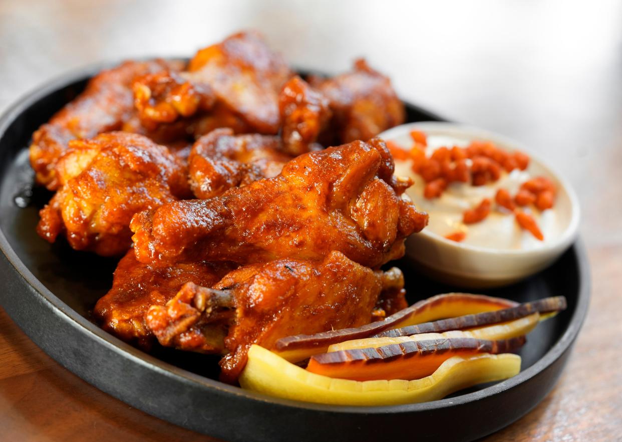 Confit wings spiced with harissa and served with labneh ranch and carrots, from the bar menu at Veritas, 11 W. Gay Street in Downtown Columbus