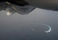 Ecuadorian navy vessels surround a fishing boat after detecting a fishing fleet of mostly Chinese-flagged ships in the Pacific Ocean