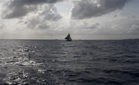 A sailboat navigates offshore of Ile-a-Vache island, off Haiti's south coast, March 25, 2014. REUTERS/stringer