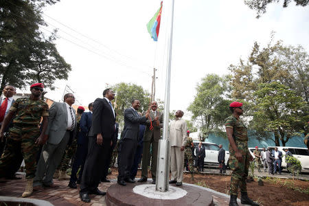 Eritrea's President Isaias Afwerki and Ethiopia's Prime Minister, Abiy Ahmed raise Eritrea's flag during a inauguration ceremony marking the reopening of the Eritrean embassy in Addis Ababa, Ethiopia July 16, 2018. REUTERS/Tiksa Negeri