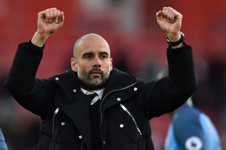 Manchester City's Pep Guardiola celebrates their victory on the pitch after their match against Southampton on April 15, 2017