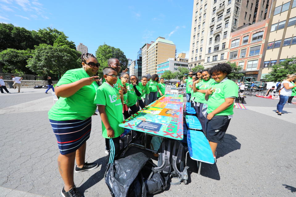 <p>Students from I.S. 117 Joseph H. Wade in the Bronx flash some peace while standing by one of the tables they created in Union Square Park in New York City on June 5, 2018. (Photo: Gordon Donovan/Yahoo News) </p>