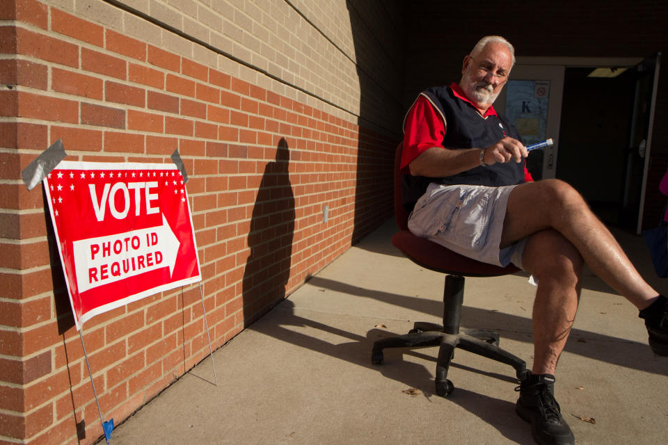 Bob Belew, a coach at Sylvan Park Elementary School in Nashville, Tenn., welcomes students and voters at a polling place at the school, on Tuesday, March 6, 2012. (AP Photo/Erik Schelzig)