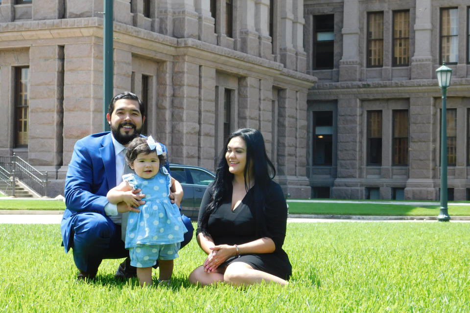 Donovon Rodriguez, chief of staff for Texas state Rep. Ray Lopez, poses on the grounds of the Texas capitol with his wife, Jenny Tavarez, and daughter, Evelyn Belle Rodriguez, for whom he is the sole provider, Monday, July 26, 2021, in Austin, Texas. Rodriguez could lose his job by Sept. 1, 2021, if legislative budget funding is not restored. (AP Photo/Acacia Coronado)