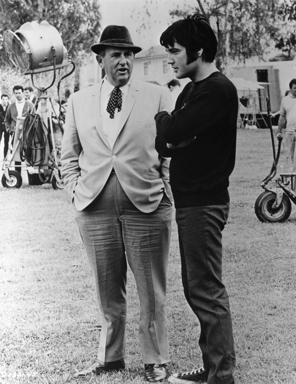 Elvis Presley confers with Colonel Tom Parker on the set of movie