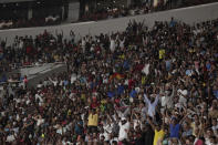 Spectators celebrate as Mutaz Essa Barshim, of Qatar, makes a clearance in the men's high jump final at the World Athletics Championships in Doha, Qatar, Friday, Oct. 4, 2019. (AP Photo/Nariman El-Mofty)