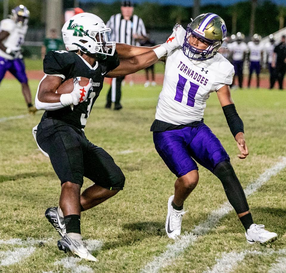 Lakewood Ranch running back Kevin Everhart (3) tries to run upfield  against Booker linebacker Dajien Walton (11) during their teams matchup in Lakewood Ranch.  MATT HOUSTON/HERALD-TRIBUNE